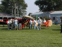 N68N @ IA27 - A crowd gathers round the rare Golden Eagle Chief shortly after landing at Antique Airfield near Blakesburg, IA during the 2004 AAA/APM National Fly-in
