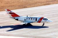 2110 @ CID - HU-25 taxiing by the control tower - by Glenn E. Chatfield