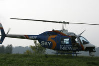 N62F - On powerline patrol somewhere in Kentucky, we had to land to wipe a bug off of teh nosemount camera lens. - by Tom Norvelle