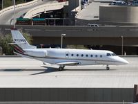 N729QS @ PHX - Taxiing south across the bridge - by John Meneely