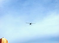 N714HH @ SZP - 1977 Cessna 150M, Continental O-200 100 Hp, takeoff climbout Rwy 04, windsock nearly limp - by Doug Robertson