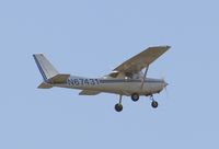 N67431 @ KSNA - Cessna 152 on short final - by Mike Khansa