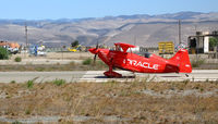 N260SP @ KIC - Vibrantly-painted ORACLE/Tutima 1981 Oliver Steven R PITTS S-2S nginning take-off roll (note: SoilServ Bell 47G cropduster and pilot in background) @ Mesa Del rey (King City) Municipal Airport, CA - by Steve Nation
