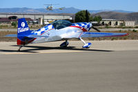 N771TA @ KIC - (Team Oracle) Tutima 2006 Extra Flugzeugbau Gmbh EA 300/L taxying (note SoilServ Bell 47G cropduster on approach) @ Mesa del Rey (King City) Airport, CA - by Steve Nation