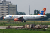 EI-DOE @ LFPG - Windjet's A320 taxies from the Charter Terminal for a southern departure from Paris CDG