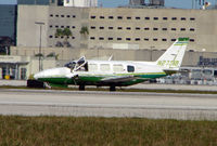 N27319 @ MIA - The mid-afternoon heat encourages the pilot to open his window whilst he waits in line for departure from Miami - by Terry Fletcher