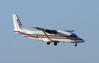 N380MQ @ MIA - Skyway Shorts 360 prepares to land at Miami - by Terry Fletcher
