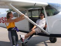 N100SD @ K50 - Ready to haul skydivers at the first Kansas Cessna Skydiving Boogie.  Cook Field, and Air Capital Drop Zone.  This airplane is owned by Jen Sharp, of Skydive Kansas.  Right to Left, Jen Sharp, Kyle - by Martin Myrtle