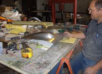 N273MD @ SZP - Dickenson Dickenson-Howard DGA-21, builder with two formed cowl bumps. Annealed aluminum sheet is held by jig in the press and pneumatic soft-nosed hammer taps the formed aluminum cowl bump shape with many, many taps into the female mold. - by Doug Robertson