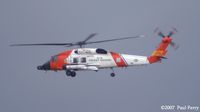 6036 @ ECG - A break in the clouds allows the vibrant USCG colors to pop - by Paul Perry