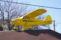 UNKNOWN @ CID - Piper Colt on top of the Flying Weenie, downtown Cedar Rapids, IA.  Even the tables have sectional charts.  Lots of airplane stuff inside - by Glenn E. Chatfield