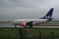 LN-RRO @ EGCC - Taken at Manchester Airport on a typical showery April day - by Steve Staunton