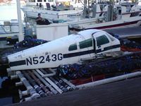 N5243G - Sitting on a small barge in Long Beach, CA - by R. Lee