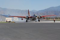 N1386C @ SBD - P-2E tanker at SBD 44 firing up for a drop - by J.G. Handelman