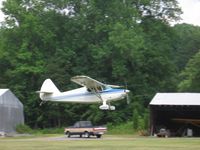N8769K - Stinson departing - by Tom Cooke