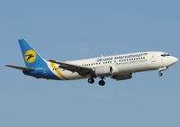 UR-GAM @ LEBL - On final to RWY 25R, view the moon behind... - by Jorge Molina