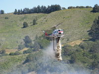 N498DF - CDF Bell UH-1H Helitak 406 dropping on fire off of State Hwy 68 ~ 4 miles NE of Monterey, CA - by Steve Nation