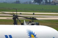 84-24022 @ CID - EH-60A taxiing for departure, passing in front of MD83.  I thought the shot was sort of a neat view of the rotor plane