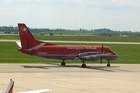 N408XJ @ CID - Taxiing to Runway 13 for departure.  Seen from second floor window of the control tower.