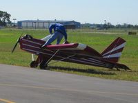 UNKNOWN @ TDZ - After starting the Rotax engine with a pull rope, the pilot boards the aircraft over the front of the wing.  EAA breakfast fly-in at Toledo, OH. - by Bob Simmermon