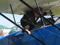 N6186L @ TDZ - Demonstrating how to deplane from the rear seat.  EAA breakfast fly-in at Toledo, OH. - by Bob Simmermon