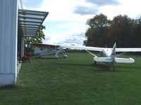 N6875M - Both stinson's at their home field. - by Terry L. Swann