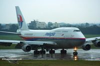 9M-MPN @ RCTP - Malaysia Airlines on a rainy day in Taipei - by Michel Teiten ( www.mablehome.com )