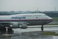 9M-MPN @ RCTP - Malaysia Airlines on a rainy day in Taipei - by Michel Teiten ( www.mablehome.com )