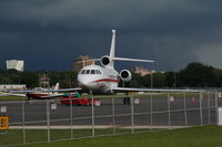 N966H @ ORL - Falcon 900EX with storm in background - by Florida Metal