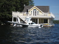 C-GFFB @ LAKE - Floating next to a boat house at Lake Rosseau, ON - by Pieter Bastemeyer