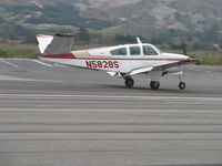 N5828S @ SZP - 1964 Beech S35 BONANZA, Continental IO-520-B 285 Hp, landing roll Rwy 22 - by Doug Robertson