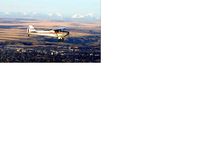 C-FSFA - Airborne over Lethbridge Alberta with the mountains in the distance - by Val Gunnlaugson