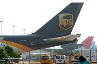N572UP @ VHHH - UPS waiting on the impressive flightline of the cargo area of Hong Kong, unfortunately hidden by fences - by Michel Teiten ( www.mablehome.com )