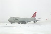 N673US @ CID - NWA9840  taxiing eastbound on Alpha to pick up the U of I football team.  Snowing with 25-30kt wind blowing snow. - by Glenn E. Chatfield