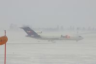 N241FE @ CID - Exiting Runway 27 at Alpha 3 to the FedEx ramp - by Glenn E. Chatfield