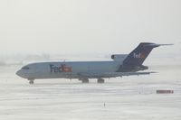 N241FE @ CID - Taxiing on Alpha to runway 27 for departure - by Glenn E. Chatfield