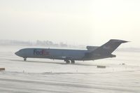 N241FE @ CID - Taxiing on Alpha to runway 27 for departure.  Looking into the sun and snow - by Glenn E. Chatfield