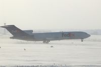 N241FE @ CID - On take-off roll Runway 27, rotating about 3000 feet.  Blowing snow, wind 25-30 kts from west - by Glenn E. Chatfield