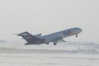 N241FE @ CID - Airborne off Runway 27 about 4000 feet.  Blowing snow, wind 25-30 kts from west - by Glenn E. Chatfield