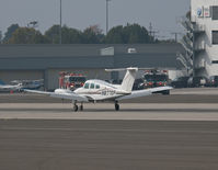 N877SP @ SMO - N877SP arriving on RWY 21 with the left engine shut down and the prop feathered. Santa Monica Airport Fire Rescue is on standby in the background. - by Torsten Hoff