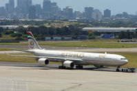 A6-EHE @ YSSY - Ethiad A340 Series 600 pulled from maintenance against the Sydney backdrop - by Terry Fletcher