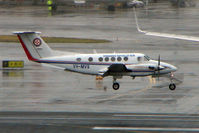 VH-MVS @ YSSY - Beech B200 landing in poor weather at Sydney - by Terry Fletcher