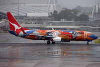 VH-VXB @ YSSY - Colourful Qantas livery brightens up a dismal Sydney day - by Terry Fletcher