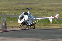G-ZZTT @ EGBJ - Hughes 300C at the Gloucestershire Airport Fuel pump - by Terry Fletcher