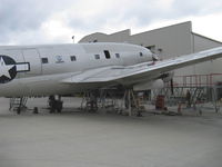 N53594 @ CMA - 1944 Curtiss-Wright C-46F COMMANDO 'China Doll', ex 'Humpty Dumpty', two P&W R-2800 radials, 2,000 Hp each, on jacks for landing gear cycle testing - by Doug Robertson