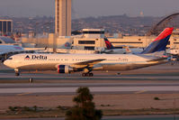N1402A @ LAX - Delta Air Lines N1402A (FLT 2089) holding short of RWY 25R after arrival on RWY 25L from Hartsfield-Jackson Atlanta Int'l (KATL). - by Dean Heald