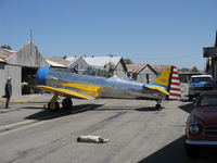 N4995C @ SZP - 1949 North American T-6C TEXAN (1949 factory reman) 'Thirsty Girl', P&W R-1340 Wasp 600 Hp, with her hangar hound snoozing in the sun - by Doug Robertson
