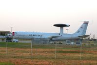 77-0352 @ TIK - Shot from another road looking behind the hangar. - by Glenn E. Chatfield