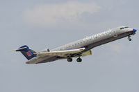 N702SK @ KSAT - CRJ climbs out - by FBE