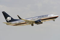 N857AM @ KSAT - shiny B737-700 retracting its gear after takeoff from KSAT - by FBE